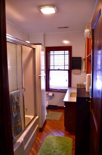 a bathroom with a shower and a sink and a toilet at The Avanti Houses in South Bend