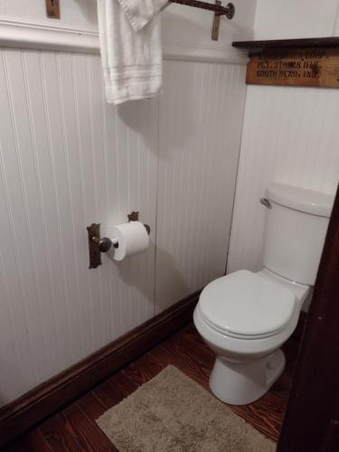 a bathroom with a toilet and a roll of toilet paper at The Avanti Houses in South Bend