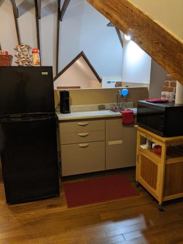 a kitchen with a black refrigerator and a sink at The Avanti Houses in South Bend