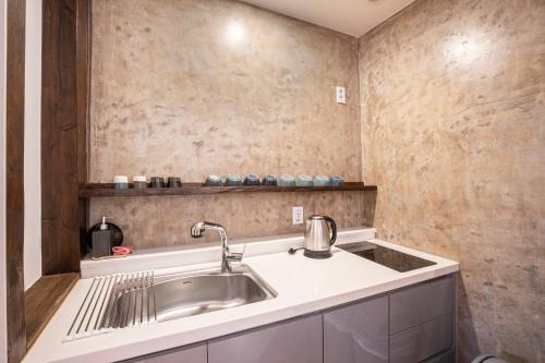 a kitchen with a sink and a counter at Olle Resort in Jeju
