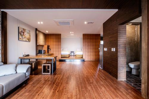a living room with a couch and a table at Olle Resort in Jeju
