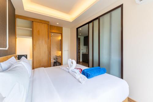 a bedroom with two white beds and a window at Aristo 2 Phuket by RESAVA in Surin Beach