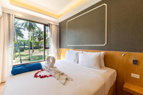 a bedroom with a bed with a towel on it at Aristo 2 Phuket in Phuket Town