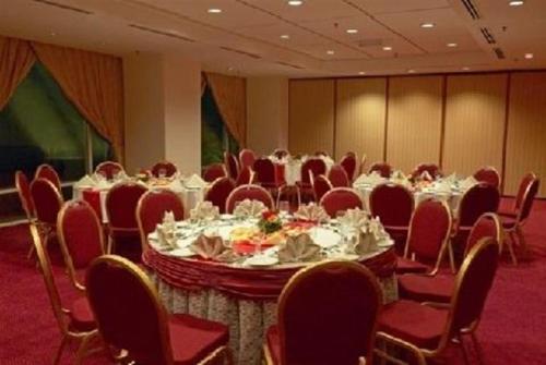 a conference room with a table and chairs and tablesktop at Hotel Royal Kuala Lumpur in Kuala Lumpur