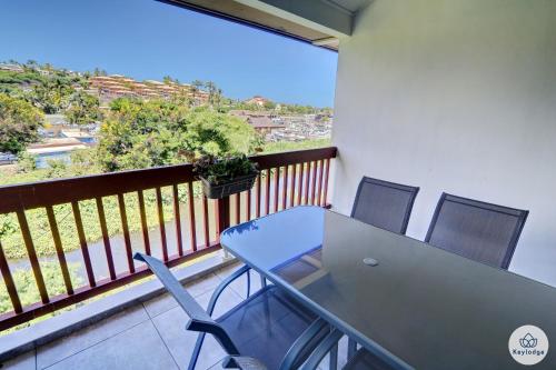 a table and chairs on a balcony with a view at T2 - Le Reflet d'O 3 étoiles - 50 m2 - Saint Gilles Les Bains in Filaos