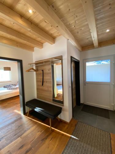 a room with a mirror and a bench in it at Haus Anton lebt in Pettneu am Arlberg