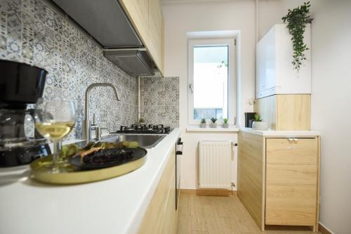 a kitchen with a plate of fruit on a counter at VACATION FEEL - 2BR Apartment with Terrace & Private Parking in Baneasa in Bucharest
