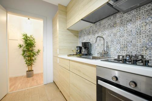 a kitchen with a sink and a counter top at VACATION FEEL - 2BR Apartment with Terrace & Private Parking in Baneasa in Bucharest