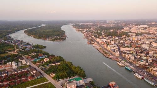 an aerial view of a river in a city at Sleepbox Hostel Suratthani in Suratthani