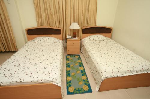 A bed or beds in a room at Red Chillies Restaurant and Guest house