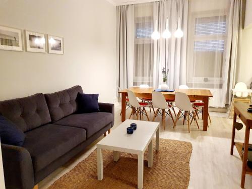a living room with a couch and a table at Apartament Paderewskiego 11 in Świnoujście
