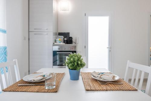 a kitchen with a table with two plates on it at La casa dei naviganti in Villasimius