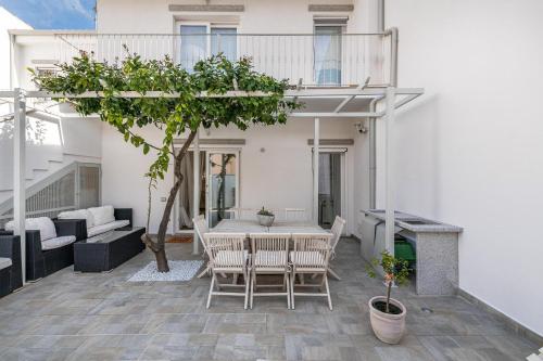 a patio of a house with a table and chairs at La Casa dei sognatori in Villasimius