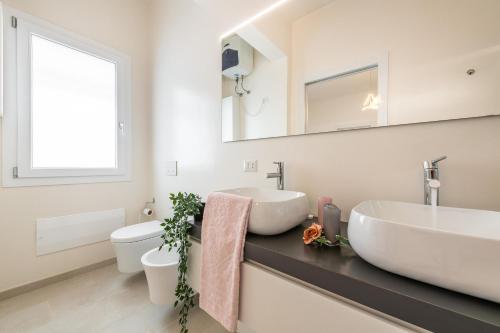 a bathroom with a sink and a toilet at La Casa dei sognatori in Villasimius