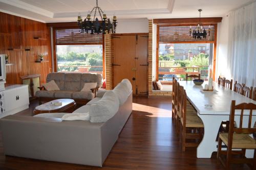 a living room with a white couch and a table at Huertas de la Fuente in Cella