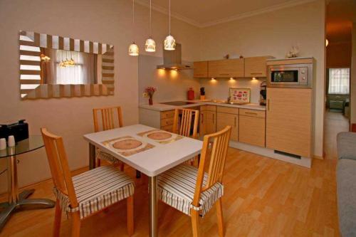eine Küche und ein Esszimmer mit Tisch und Stühlen in der Unterkunft Villa Seestern, App. 3 in Bansin
