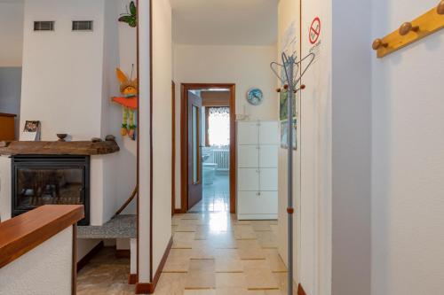 a hallway with a fireplace in a house at Maranta Aprica Apartment in Aprica