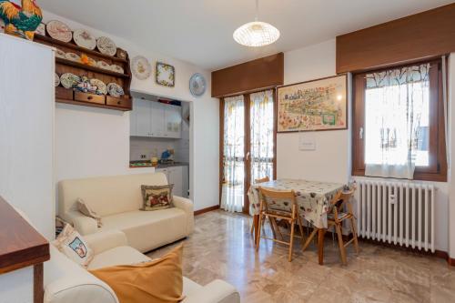 a living room with a couch and a table at Maranta Aprica Apartment in Aprica