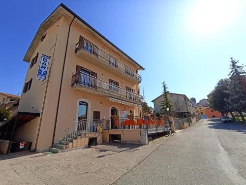 a building with balconies on the side of a street at TraMonti Apartments in Poggio Picenze