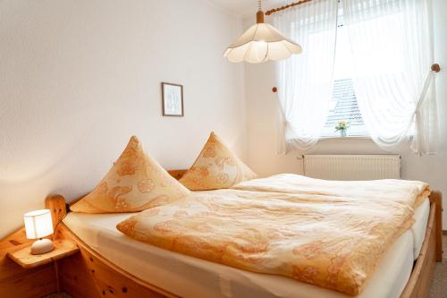 a bedroom with a bed and a window at Haus Nordstrand Berliner Strasse 1a in Büsum