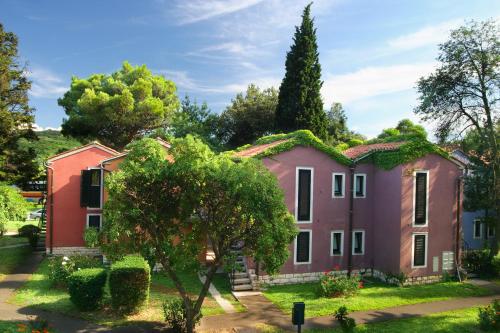 an old house with a moss covered roof at Holiday Park Vile - Terme Krka in Strunjan