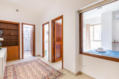 a living room with a window and a bedroom at Teatro Politeama and Teatro Massimo Cozy Apartment in Palermo