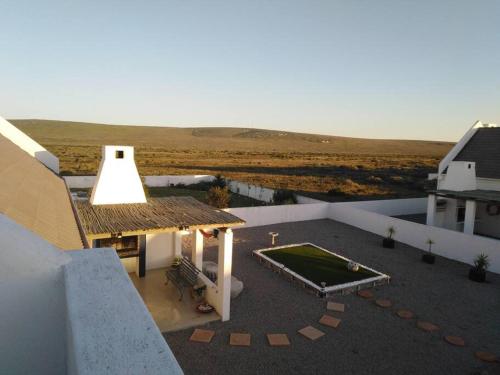 an aerial view of a building with a yard with a pool at Huis Maria in Golden Mile in Stompneusbaai