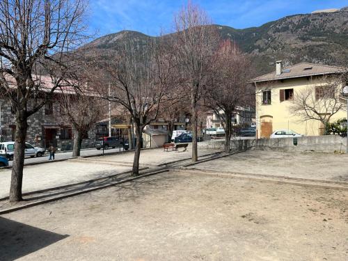 a group of trees on a street with a building at magnifique appartement cosy et familial in Valdeblore