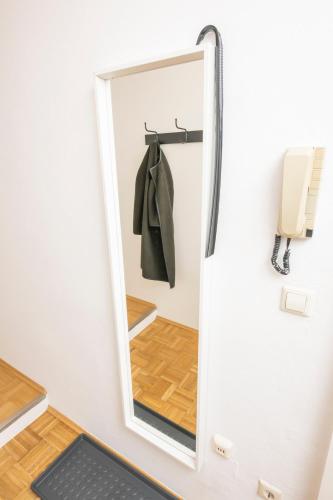 a mirror in a room with a door at Zum Grazer Uhrturm in Graz