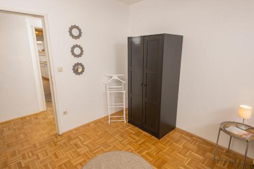 a room with a black cabinet next to a door at Zum Grazer Uhrturm in Graz