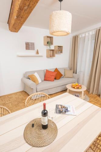 a living room with a couch and a table at Zum Grazer Uhrturm in Graz
