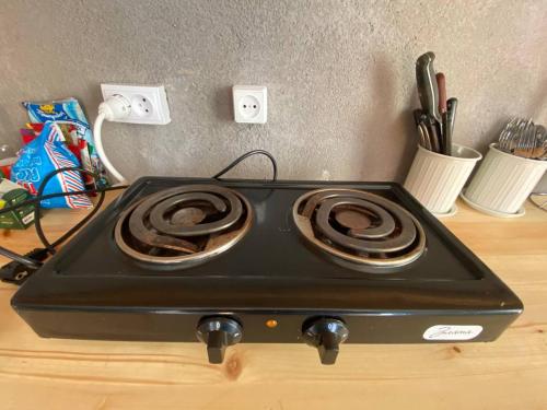 a stove top oven sitting on top of a counter at Darya Hostel Jyrgalan in Dzhergalan