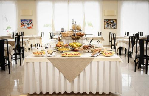 a white table with food on it in a room at Grand Hotel & Riviera in Lido di Camaiore