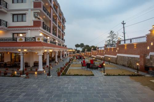a building with chairs and tables in a courtyard at Hotel Ghyampe Dada in Bhaktapur
