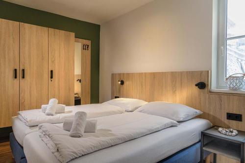 a bedroom with two beds with white sheets and a window at AlpenParks Apartment & Ferienresort Rehrenberg Viehhofen in Viehhofen