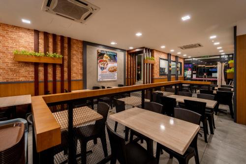 a restaurant with tables and chairs and a bar at East Riverine Boutique Hotel in Kuala Lumpur