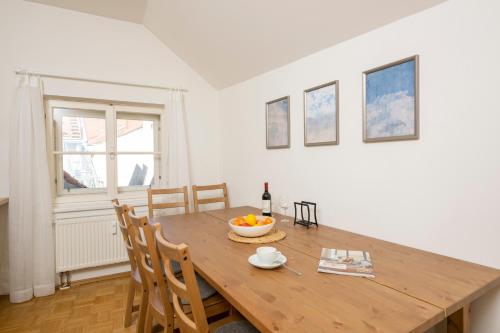 a dining room with a wooden table and chairs at Cozy Kunsthaus GRAZ in Graz