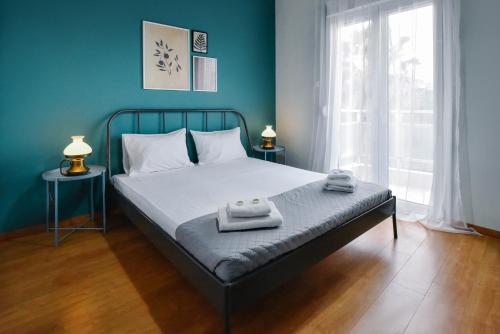 a bedroom with a bed with two towels on it at City Vibes "by Checkin" in Heraklio Town