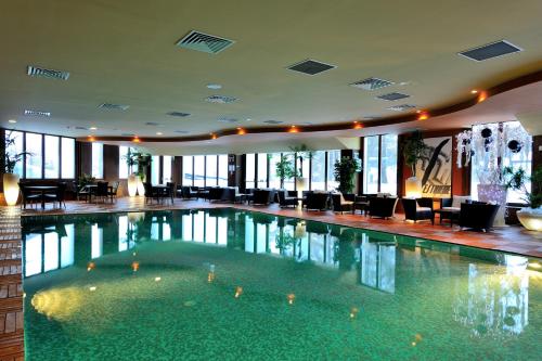 a large swimming pool in a hotel lobby at Principi di Piemonte Sestriere in Sestriere