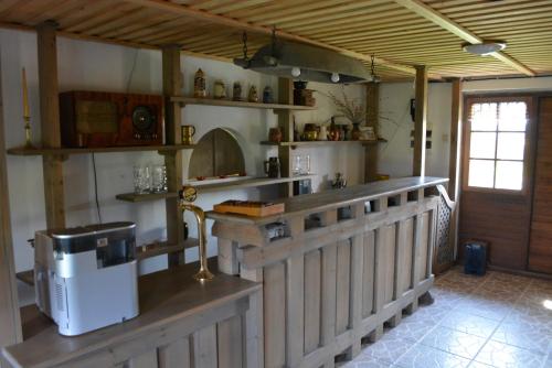 a kitchen with a counter and a stove in a room at Viesu nams Pūpoli in Dundaga