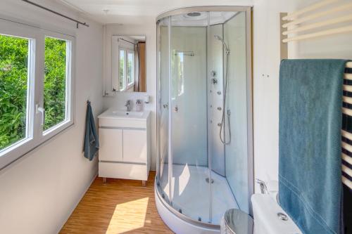 a bathroom with a shower and a sink at Casa Amarelo-Tiny House with fantastic view-pool and close to the beaches in Silves