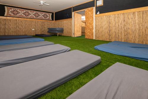 a room with four beds on the grass at Ras Hasita in H̱aẕeva