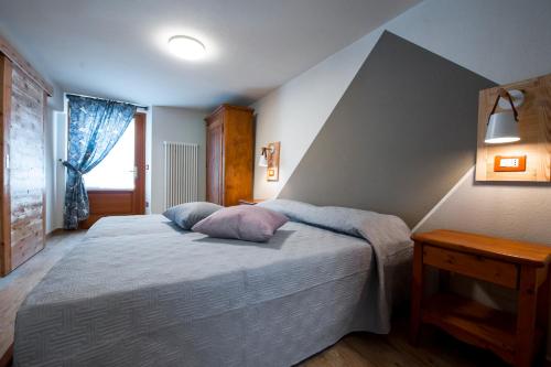 a bedroom with a bed with a pillow on it at Lou Rosé in Donnas