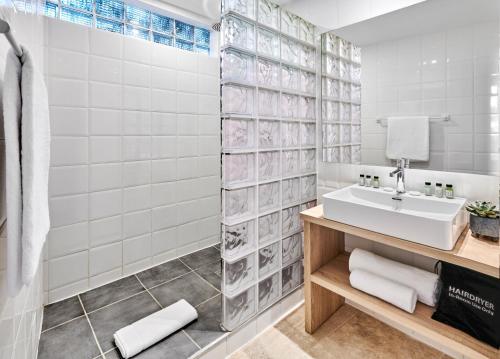 a bathroom with a sink and a shower at Hotel Le Suquet Cannes in Cannes