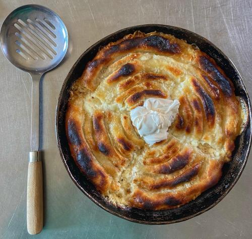 a pie in a pan with whipped cream on top at Konak Umoljani in Umoljani