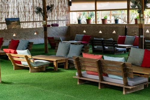 a group of chairs and tables on a green floor at Ras Hasita in H̱aẕeva