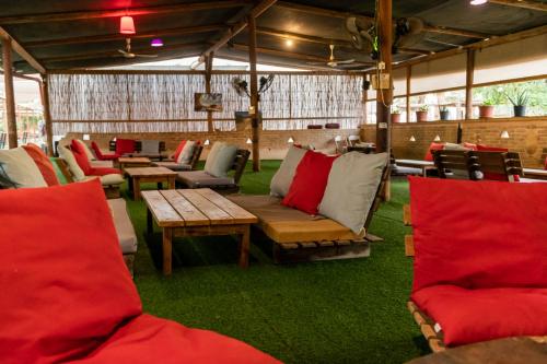 a group of chairs and couches in a tent at Ras Hasita in H̱aẕeva