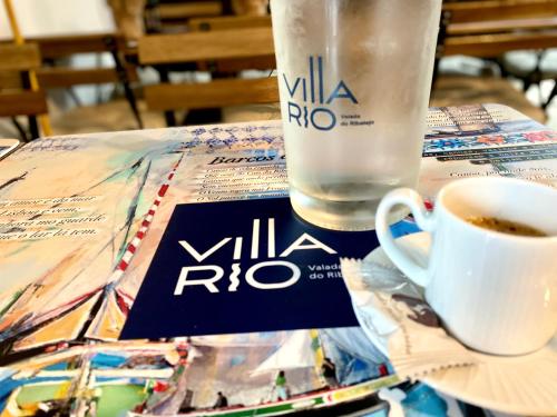 a table with a cup of coffee and a glass of water at Villa Rio by Valada Village in Valada