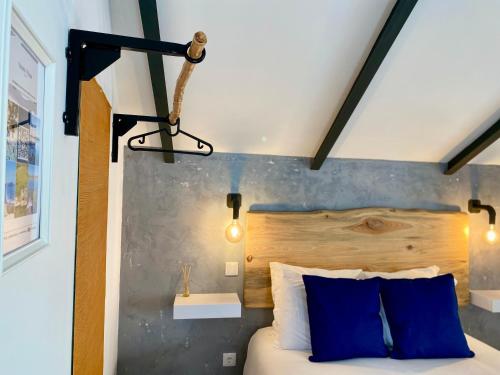 a bedroom with a bed with blue pillows at Villa Rio by Valada Village in Valada