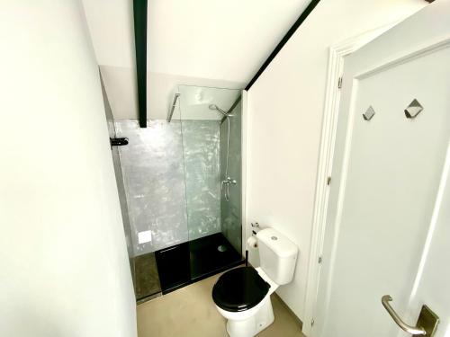 a bathroom with a toilet and a glass shower at Villa Rio by Valada Village in Valada